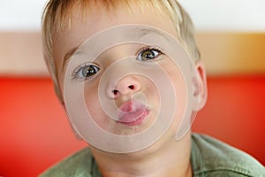 Young boy drinking from glass of fresh water