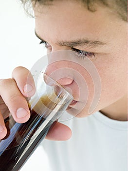 Young boy drinking soda