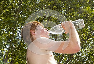 Young boy drinks water out