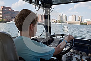 Young boy is driving amphibian car on the water photo