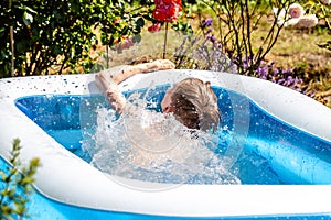 Young boy drowning in the swimming pool in the summer