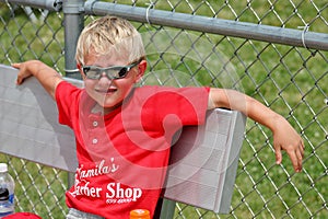 Young Boy in the Dugout in Between Innings