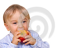 Young boy eating apple