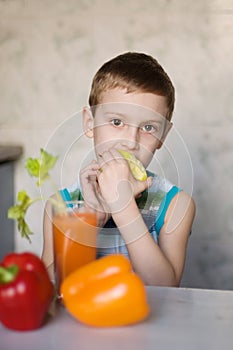 Young boy eating apple and vegetables