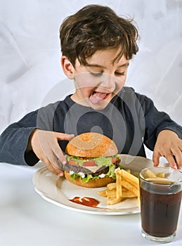 Young boy eating chessburger