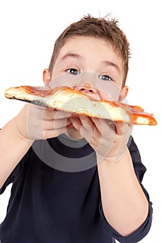 A young boy eating pizza photo