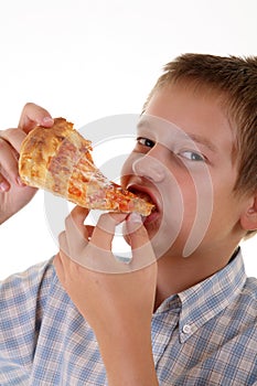 Young boy eating pizza