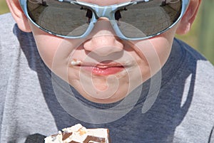 Young boy eating popsicle