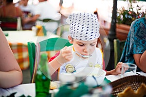 Young boy eating soup