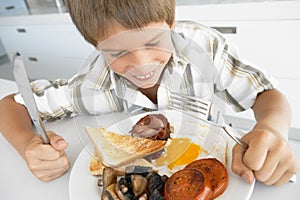 Young Boy Eating Unhealthy Fried Breakfast