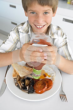 Young Boy Eating Unhealthy Fried Breakfast