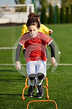 A young boy is energetically kicking