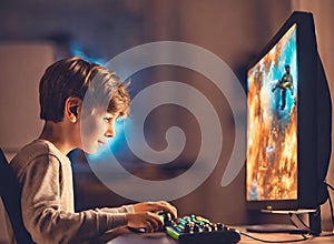 A young boy engrossed in a computer game