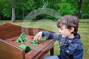 Child playing gioco della rana table game outdoors photo