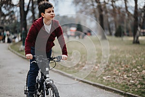 Young boy enjoying a leisurely bike ride in the urban park