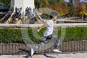 Young boy enjoying playing at the playground in the park.