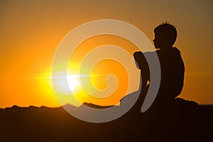 Young boy enjoying sunset