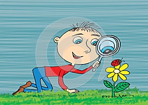 Young boy exploring nature in a meadow with a magnifying glass l