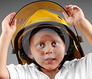 Young boy in fireman's helmet