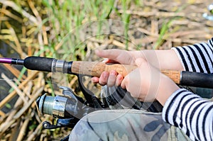 Young boy fishing with a spinning reel