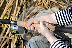 Young boy fishing with a spinning reel