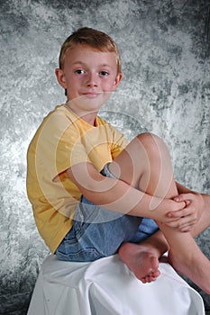 Young boy in front of photo ba