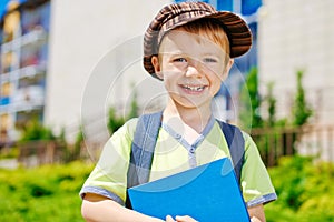 Young boy in front of school