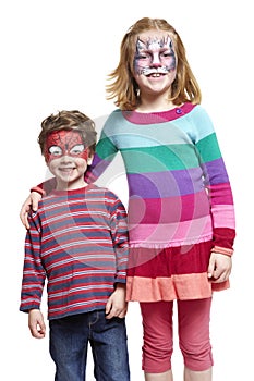 Young boy and girl with face painting of cat and spiderman