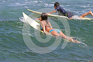 Young boy and girl go surfing in Hawaii