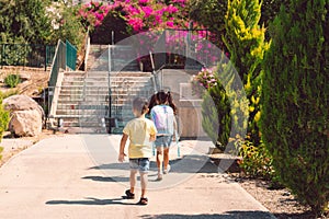 A young boy and girl going back to school.