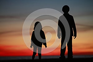 Young boy and girl in silhouet