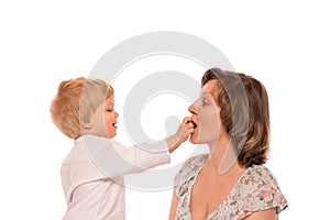 Young boy giving a candy to her mother