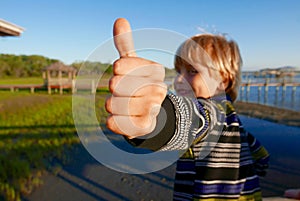 Young boy giving a thumbs-up gesture