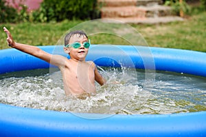 Young boy with goggles in swimming pool