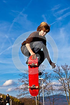 Young boy going airborne with his skateboard