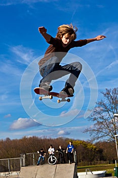 Young boy going airborne with his skateboard