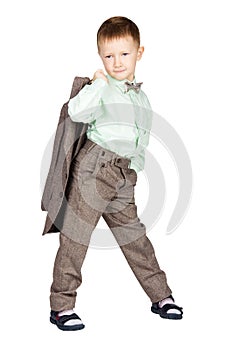 Young boy in grey suit and bow tie holding his jacket and looking on camera (isolated on white)