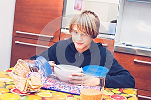 Young boy having breakfast before going to school New day of everyday life