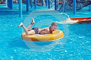 Young boy having fun in aquapark