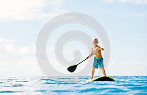 Young Boy Having Fun Stand Up Paddling