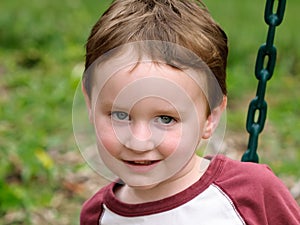 Young boy having fun on a swing