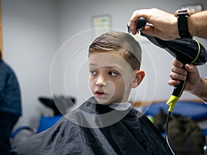 Young boy having his hair done