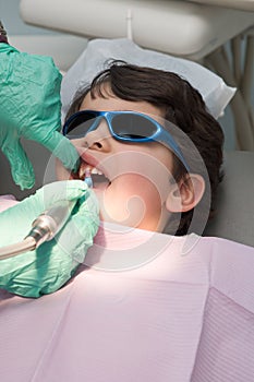 Young boy having his teeth polished at the dentist