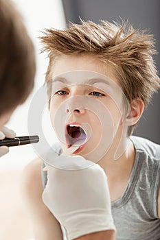 Young boy having throat check up