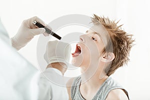 Young boy having throat examination