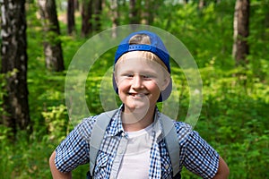 Young boy hiking in forest