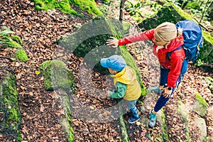 Young boy hiking with mother