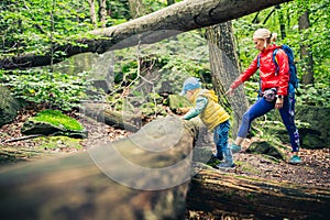 Young boy hiking with mother