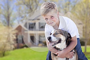 Young Boy and His Dog in Front of House