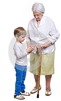 Young boy and his great grandmother trying to solve cube puzzle